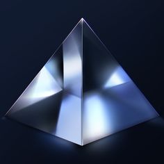 a metallic pyramid on a dark background with the light reflecting off it's sides