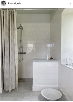 a bathroom with white tile walls and flooring is shown in this image, there is a bathtub next to the shower