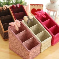 three different colored boxes with bows on them