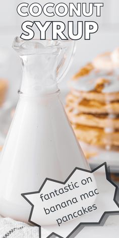 a bottle of coconut syrup sitting on top of a table next to crackers and pancakes