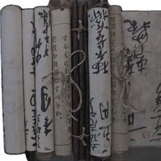 an old book with writing on it is sitting in front of a white background and tied up