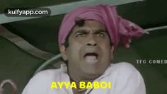 a man with a pink turban on his head is making a funny face