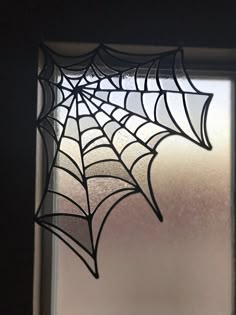 a glass window with a spider web on it