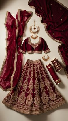 Elevate your bridal style with this stunning maroon lehenga! ✨ The intricate golden embroidery and glamorous accessories make it perfect for any grand celebration. Ready to shine? 💖 #BridalInspo #GlamourGoals #LehengaLove Jewellery With Maroon Lehenga, Maroon Wedding Lehenga Bridal, Gold And Red Lehenga Style, Maroon Lehenga Designs, Wedding Lehenga Maroon, Maroon Colour Lehenga Bridal, Maroon Red Lehenga, Maroon Lehenga Choli, Maroon Silk Lehenga