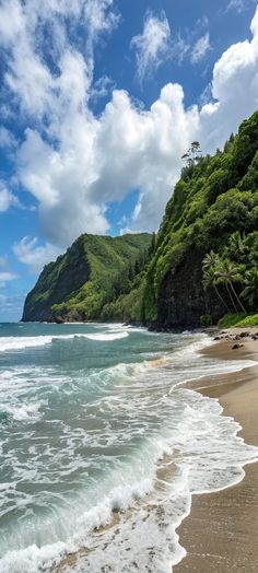the beach has waves coming in from the water and green trees on the hill side