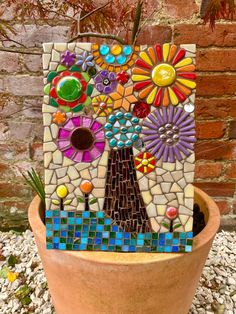 a potted plant that has some kind of mosaic art on the side of it