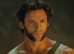 a close up of a person wearing a shirt and suspenders with a necklace on his neck