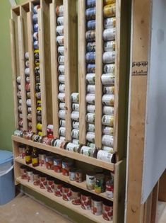 a wooden shelf filled with lots of cans