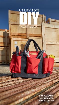 a red and black bag sitting on top of a wooden floor next to crates with tools in it