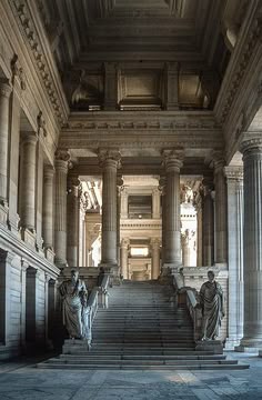 an old building with columns and statues in it