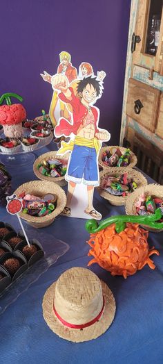 a table topped with lots of cakes and cupcakes