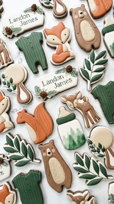 the cookies are decorated with forest animals and trees on them, along with words that read landor james