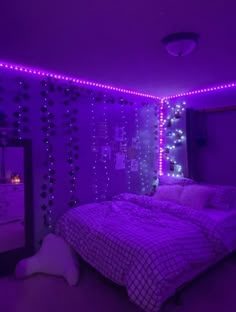 a bedroom with purple lights on the walls