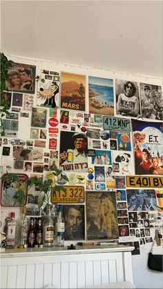 the wall is covered with many different posters