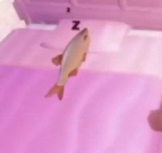 a fish that is sitting on a bed with pink sheets and pillows in the background