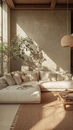 modern living room design, cozy ambiance, warm lighting, stylish furniture, greenery touches, minimalistic decor, high ceiling, natural materials, wide-angle shot, soft colors, Pinterest-worthy