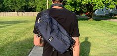 a man with a back pack walking down a sidewalk