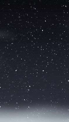 the sky is filled with snow as it appears to be dark and full of stars