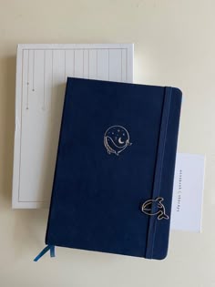 a blue notebook sitting on top of a white table
