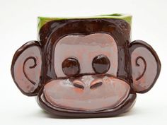 a ceramic monkey head vase sitting on top of a table