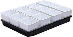 twelve white plastic containers stacked on top of each other in a black tray with dividers