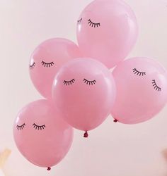 pink balloons with eyes and eyelashes on them