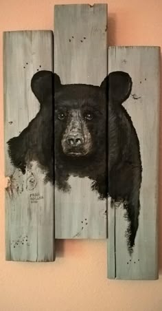 a painting of a black bear on wood