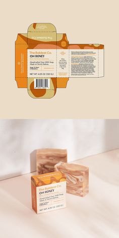 two soap bars sitting next to each other on top of a white surface with an orange and yellow label
