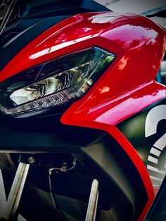 the front end of a red and black motorcycle
