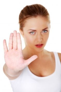a woman holding her hand up in the air with an evil look on her face