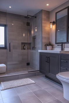 a large bathroom with a walk in shower next to a toilet and bathtub area