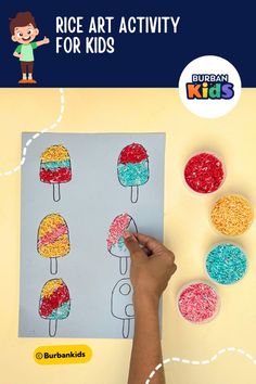a child's hand is drawing an ice cream sundae on a piece of paper