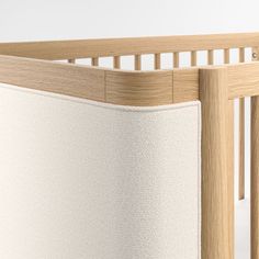 an image of a crib that is made out of wood and white linens