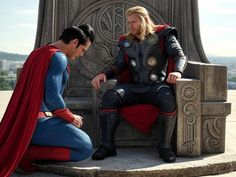 two men dressed as superman and thor in front of a statue