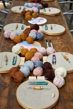 the table is set up with yarn and crochet hooks