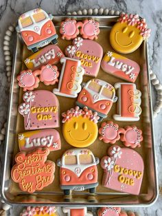 decorated cookies in the shape of cars and flowers on a cookie sheet with words happy birthday