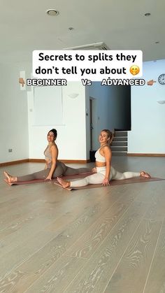 two women sitting on the floor doing yoga