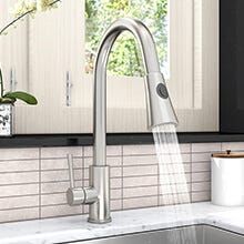 a kitchen sink with a faucet running water from it's spout