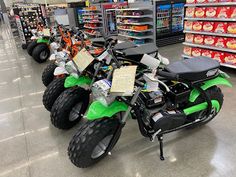 a green and black dirt bike in a store