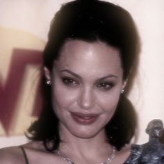 a woman holding an award in her right hand