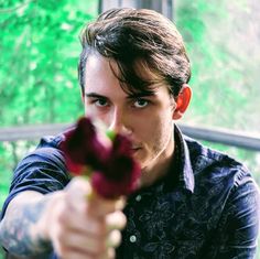 a man holding a flower in his right hand