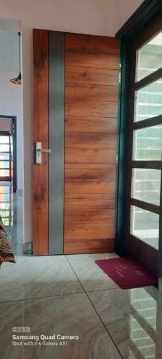 the entrance to a modern house with wooden doors