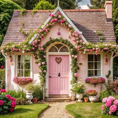 a pink house with flowers on the front door