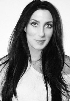 a black and white photo of a woman with long hair wearing a t - shirt