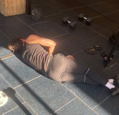 a man laying on the ground with his head down