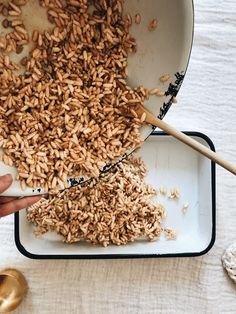 a person is scooping seeds into a bowl