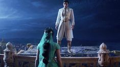 a man and woman standing on top of a bed in front of a night sky