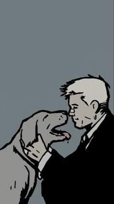 a man in a suit feeding another man with a piece of food on his finger