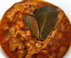 a close up of a bowl of food with a leaf on the top of it