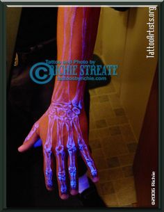 a person's hand with blue and pink glow on it